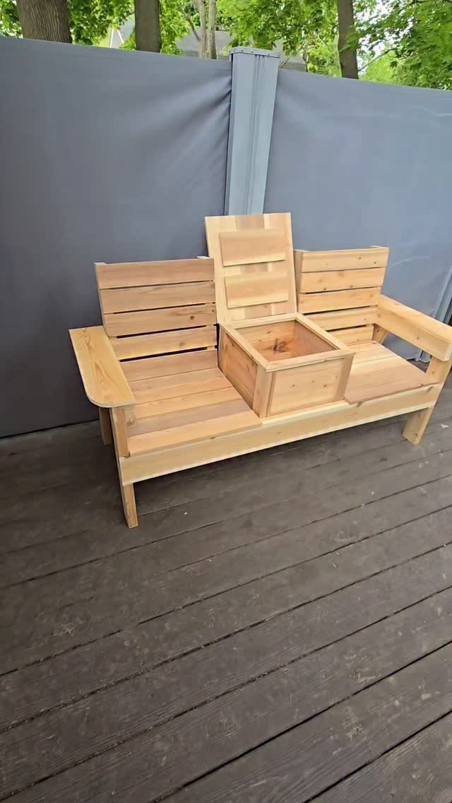 9 DIY Outdoor Furniture Ideas: Pallet Tables to Adirondack Chairs 6 A light wood outdoor loveseat with a central storage compartment on a dark deck.