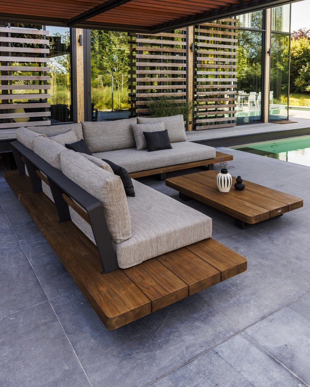 9 DIY Outdoor Furniture Ideas: Pallet Tables to Adirondack Chairs 2 Modern wooden outdoor sofas with grey cushions and a matching coffee table on a patio.