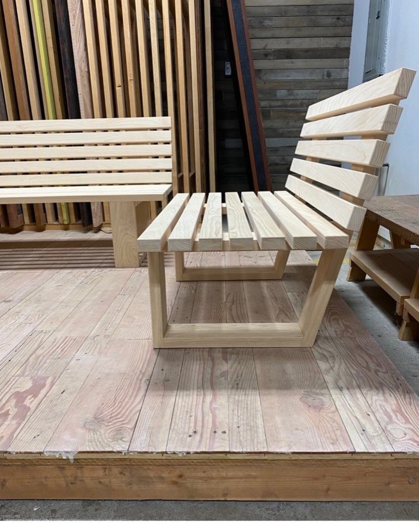 9 DIY Outdoor Furniture Ideas: Pallet Tables to Adirondack Chairs 7 Light wood slatted lounge chair and bench sitting on a wooden platform.