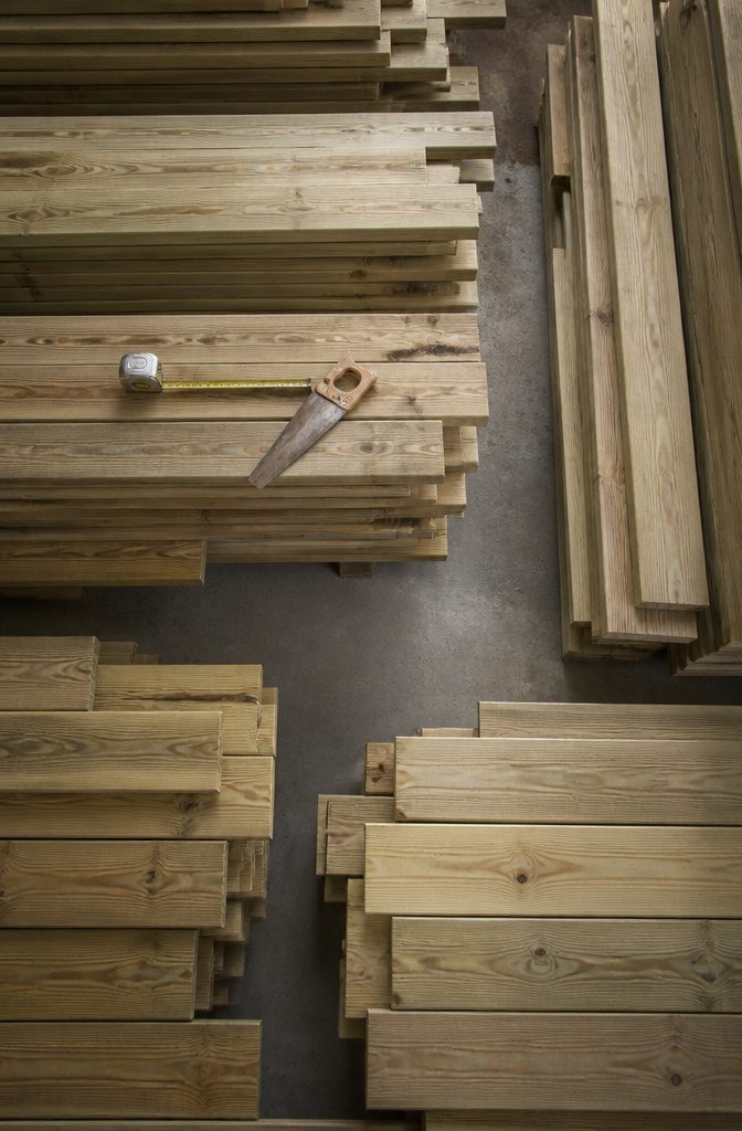 Collection of construction-grade lumber and wood for chair building.
