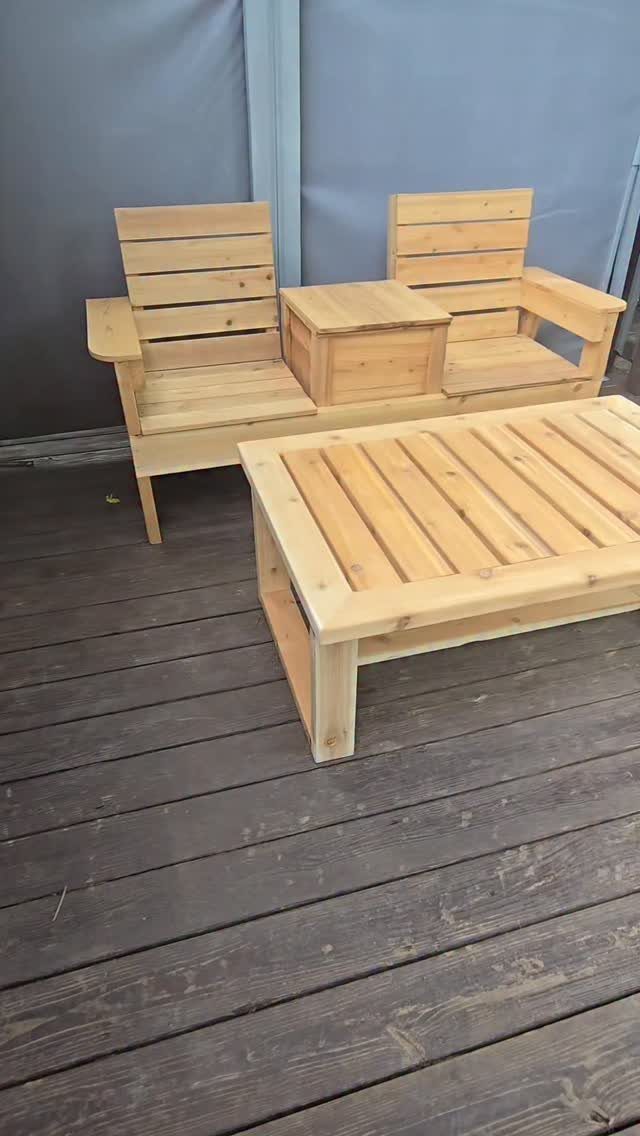 Wooden outdoor furniture set including a two-seater bench and a rectangular coffee table on a deck.